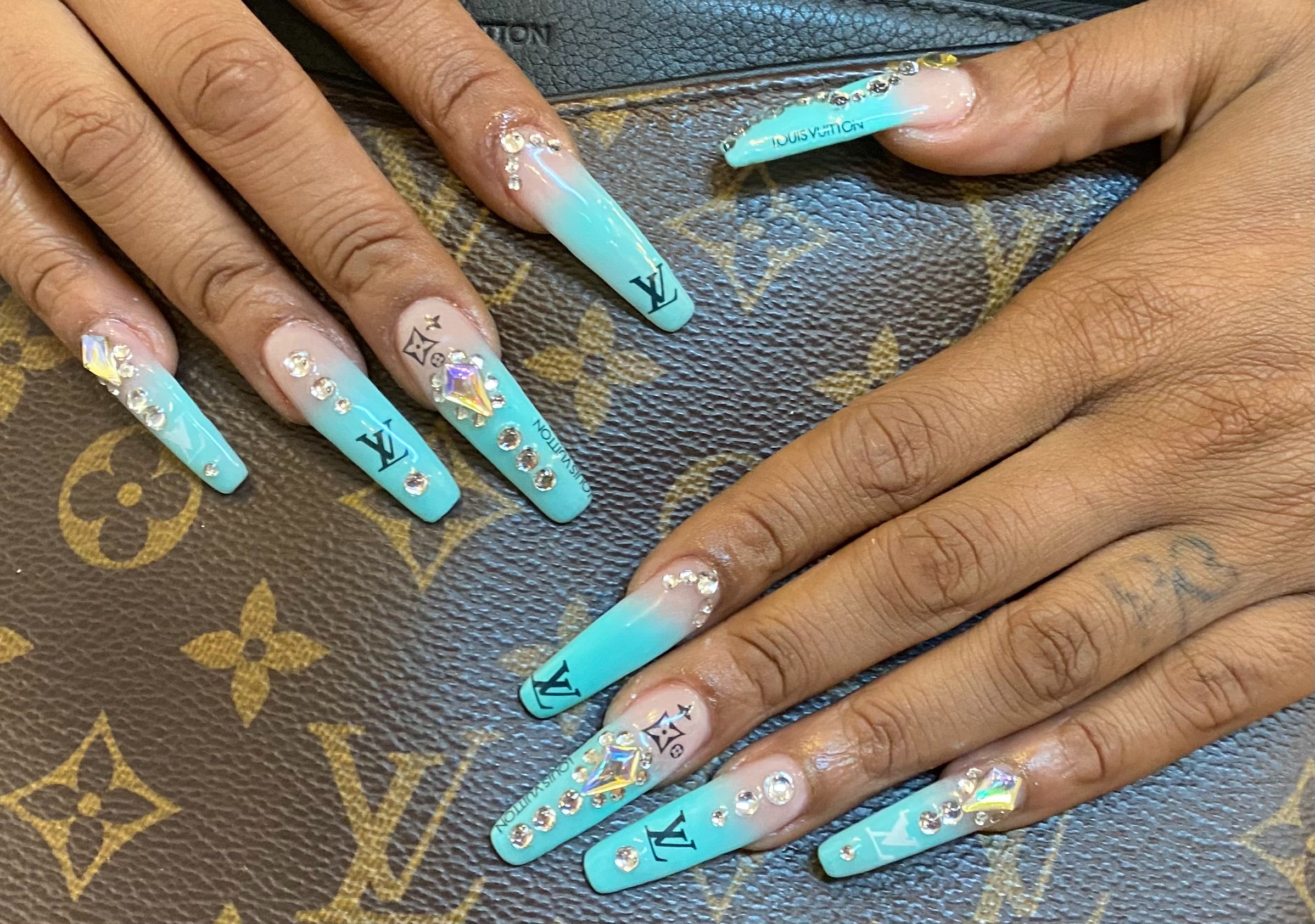 Luxury turquoise designer manicure with Louis Vuitton accents